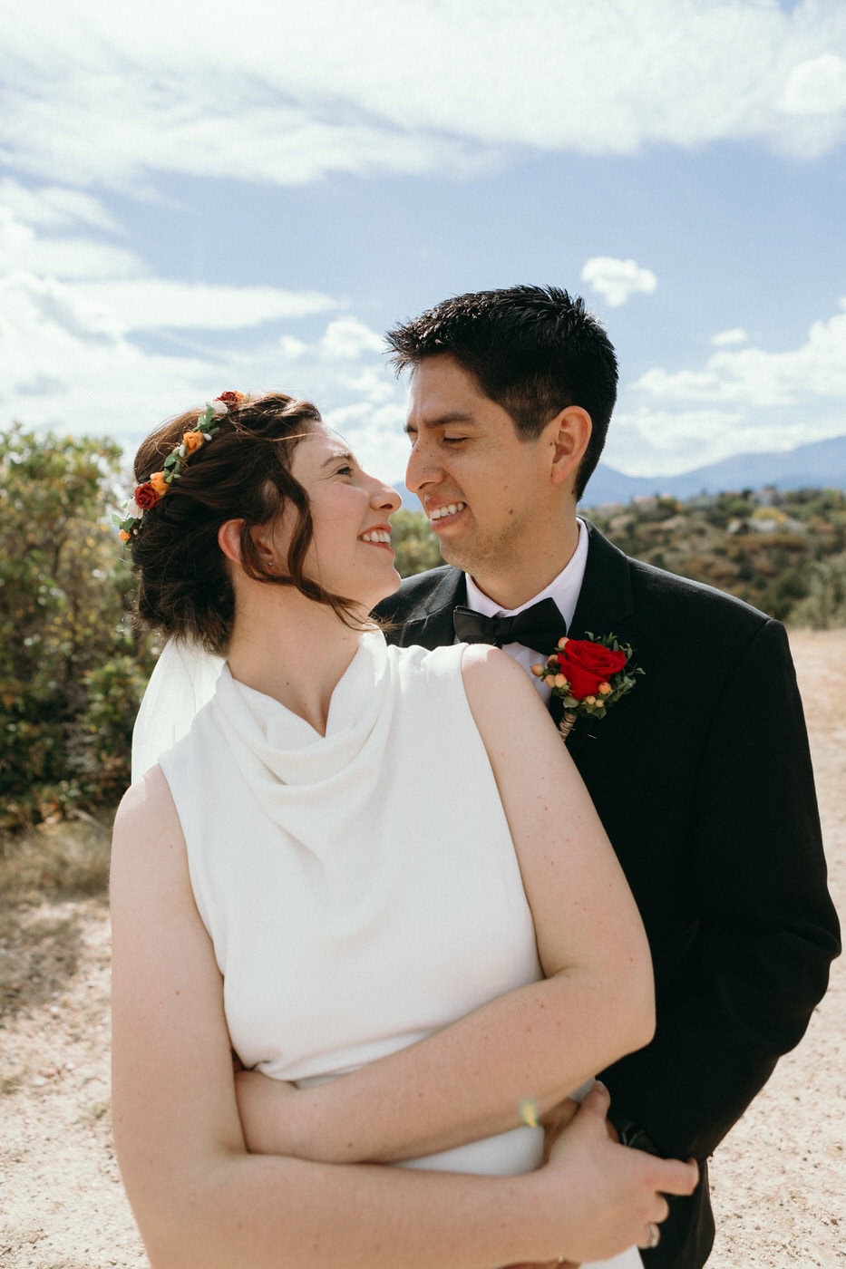 bride and groom embracing and turned towards each other in profile view
