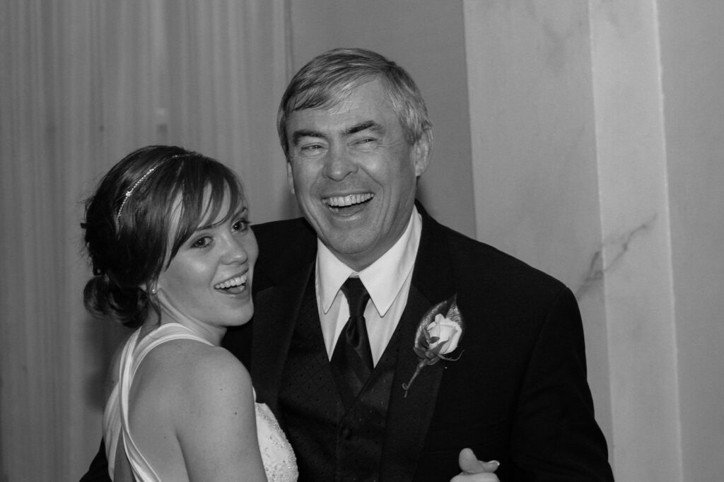 A father and his daughter share a dance at a wedding reception