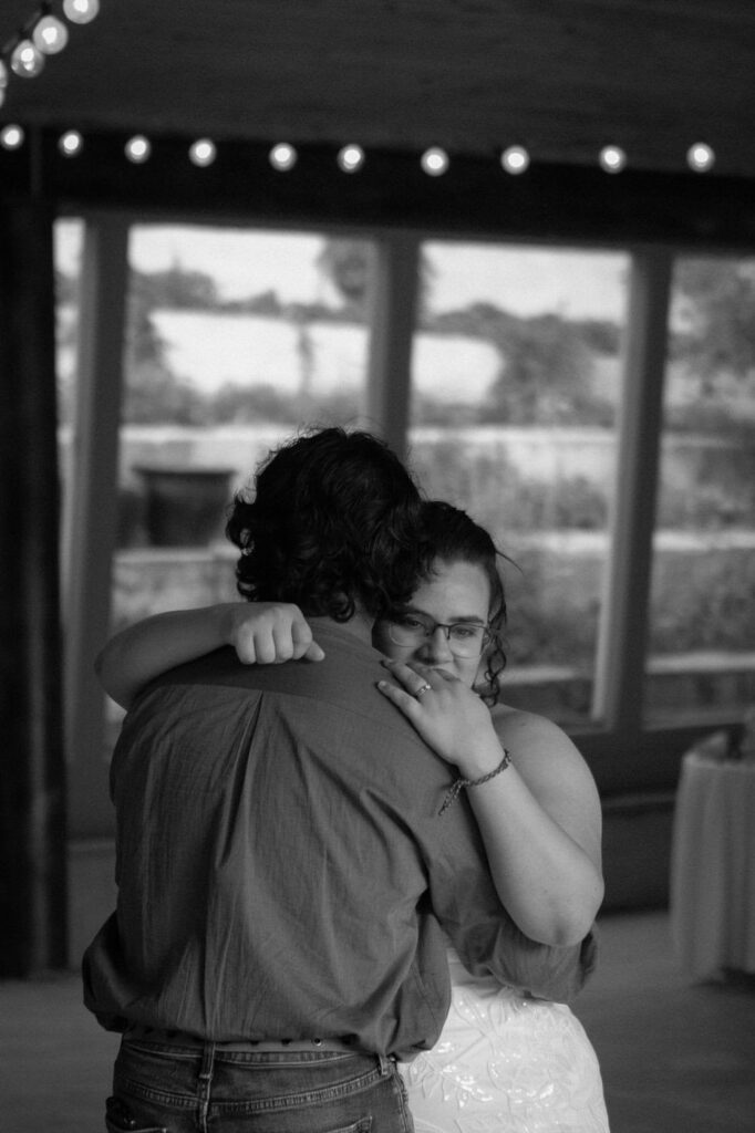 a father embraces his daughter during the dance at the reception